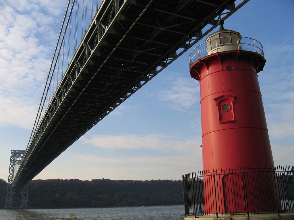 The little red lighthouse that now sits in the shadow of the Washington Bridge, might be tiny, but it played a big role in helping guide many a ship. Photo credit Flickr user CPW View.